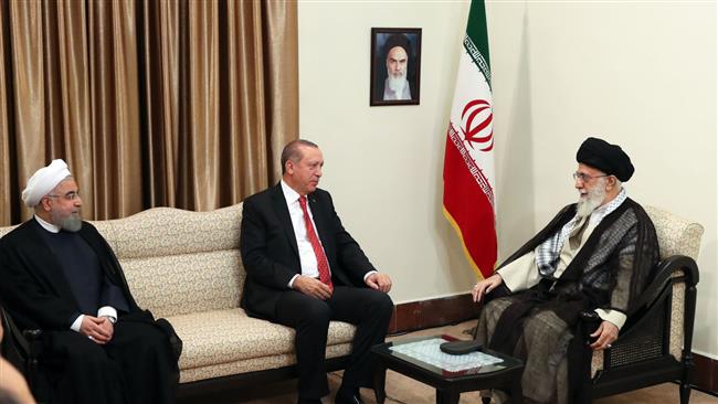 Iranian President Hassan Rouhani (L) attends a meeting between Leader of the Islamic Revolution Ayatollah Seyyed Ali Khamenei (R) and Turkish President Recep Tayyip Erdogan in Tehran on October 4, 2017. (Photo by leader.ir)
