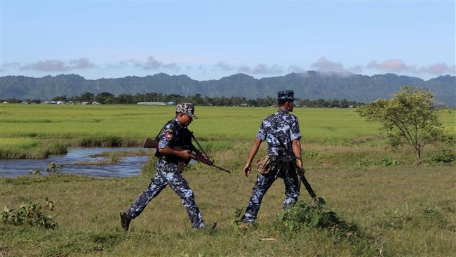 This picture, taken on October 10, 2017, shows Myanmar Border Guard police walking near the Ah Nout Pyin Village near Rathedaung in Northern Rakhine State. (By AFP)
