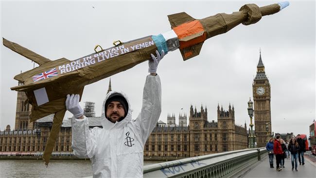An Amnesty International activist shows off a homemade replica missile on Westminster Bridge in London during a March 2016 demonstration against British arms sales to Saudi Arabia. (File photo)
