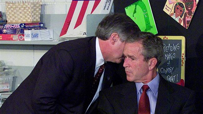 White House Chief of Staff Andrew Card whispers into the ear of President George W. Bush to give him word of the plane crashes at the World Trade Center, during a visit to the Emma E. Booker Elementary School in Sarasota, Florida, on September 11, 2001. (Photo by AP)

