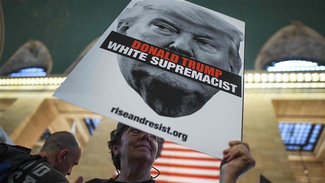 A protester displays a placard against US President Donald Trump during a demonstration against white supremacy inside the Grand Central Station in New York on September 18, 2017. (AFP photo)
