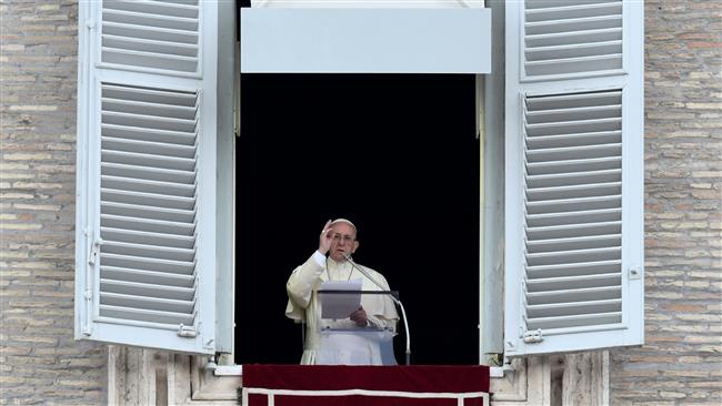 Pope Francis delivers his blessing to the crowd from the window of the apostolic palace overlooking St Peter