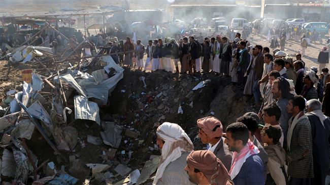 People gather at the site of a Saudi airstrike in the northwestern city of Sa