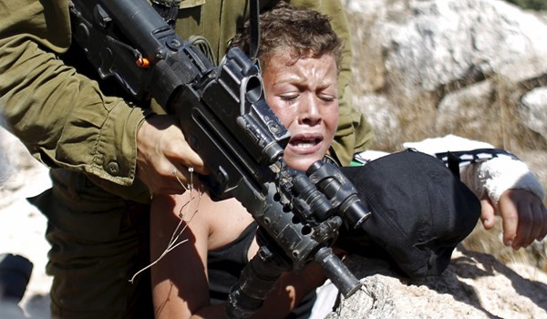 Palestinian boy detained by an Israeli soldier