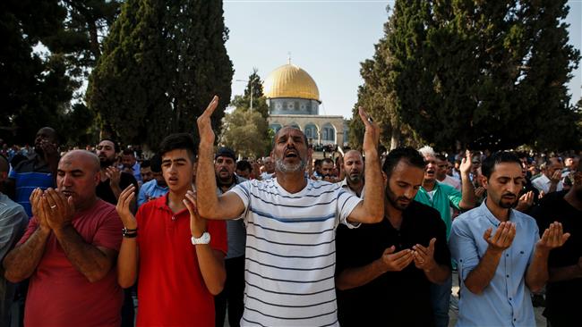 Palestinian Muslims raise their hands during prayers in the Haram al-Sharif, in the Old City of Jerusalem al-Quds, July 27, 2017. (Photo by AFP)
