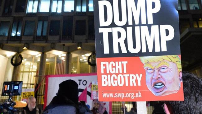 People take part in a protest organized by Stand Up To Racism outside the US Embassy in London. (Photo by Press Association)
