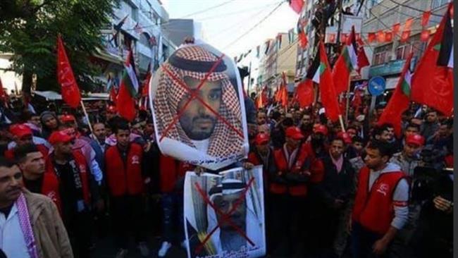 Palestinian protesters carry crossed-out pictures of Saudi Crown Prince Mohammad bin Salman and his father King Salman during a protest in the Gaza Strip on December 9, 2017.
