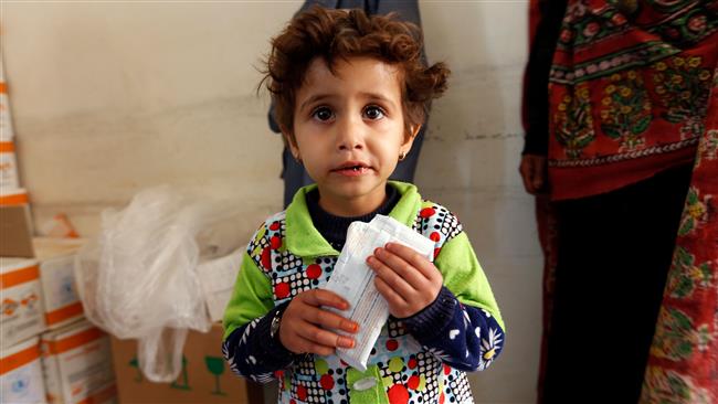 A Yemeni child suffering from malnutrition eats biscuits with nutritional supplements at a medical centre on the outskirts of the Yemeni capital Sana’a, on December 11, 2017. (Photo by AFP)
