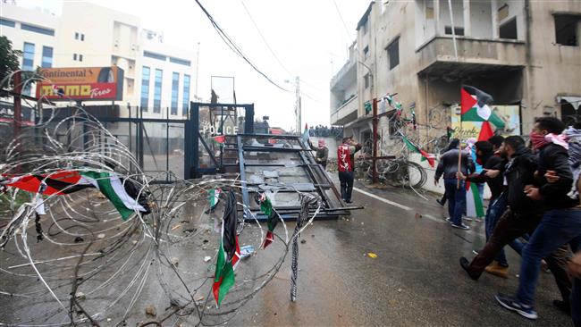 Protesters shout slogans during a demonstration outside the US embassy in Beit Awkar, on the outskirts of the Lebanese capital Beirut, on December 10, 2017, to protest against Washington