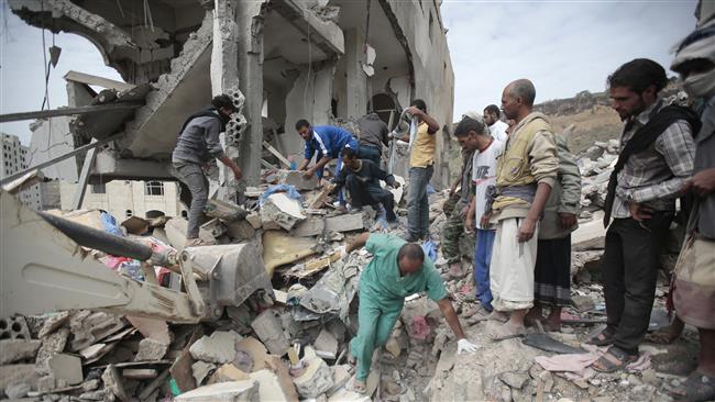 People inspect the rubble of houses destroyed by Saudi-led airstrikes in the capital city of Sana