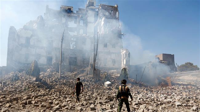 Houthi fighters inspect the damage after a Saudi airstrike targeted the presidential palace in the Yemeni capital, Sana