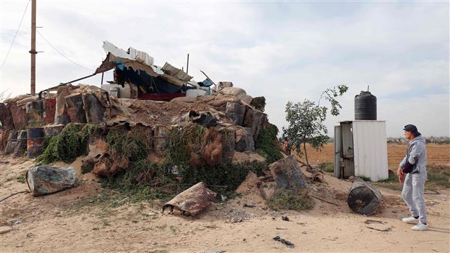 A Palestinian inspects damage to a Hamas post that was hit by Israeli tank and aircraft fire the previous night, east of the southern Gaza Strip city of Khan Yunis, on December 12, 2017. (Photo by AFP)
