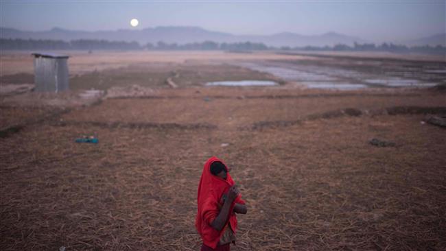 In a photo taken on December 3, 2017, a Rohingya girl stands on the edge of the Naybara refugee camp in Cox