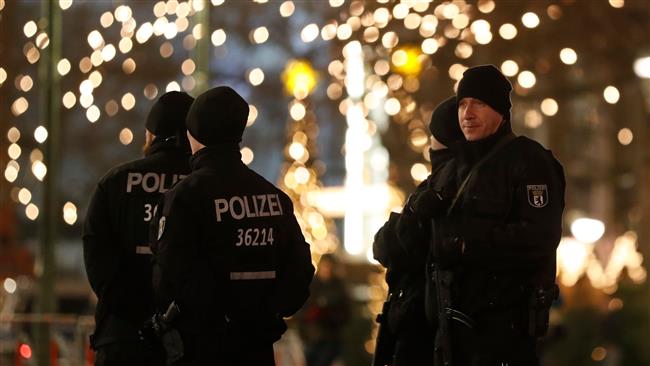Police officers patrol at the Christmas market at Breitscheidplatz on the day of the anniversary of the 2016 deadly truck attack in Berlin, in front of the Kaiser-Wilhelm-Gedaechtniskirche (Kaiser Wilhelm Memorial Church), December 19, 2017. (Photo by AFP)
