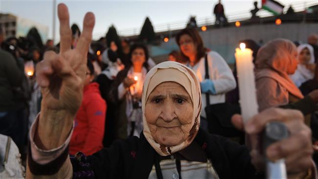 People take part in a demonstration called up by local and Palestinian NGOs to denounce the US decision to recognize Jerusalem al-Quds as Israel