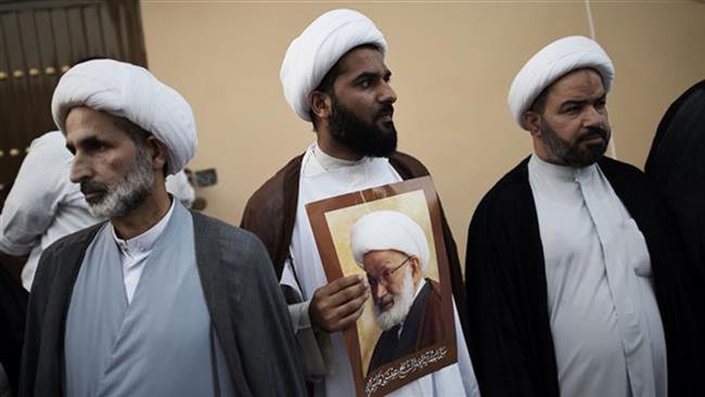 Shia Bahraini clerics attend a protest against the revocation of the citizenship of top cleric Sheikh Isa Qassim (portrait) on June 20, 2016, near Qassim