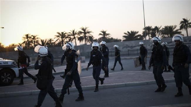 Bahraini police leave after dispersing protesters during clashes that erupted following the funeral of a teen killed in a police chase in the village of Shahrakan, south of the capital Manama, April 5, 2016. (Photo by AFP)
