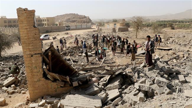 People gather at the site of a Saudi airstrike that destroyed a house on the outskirts of the city of Sa