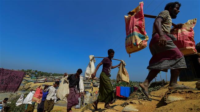 Rohingya Muslim refugees carry bricks to make a road at the Kutupalong refugee camp in Bangladesh. (Photo by AFP)
