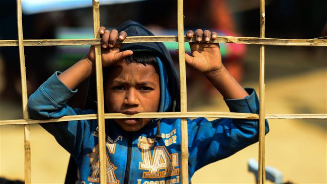 A Rohingya Muslim refugee looks on at a relief distribution point at Kutupalong refugee camp in Bangladesh