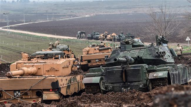 Turkish tanks are parked near the Syrian border at Hassa in Turkey