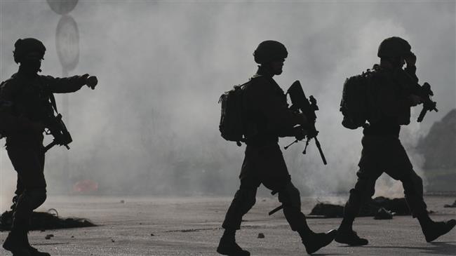 Israeli forces cross a street during clashes with Palestinian protestors at Hawara checkpoint, south of the West Bank city of Nablus, on December 29, 2017. (Photo by AFP)
