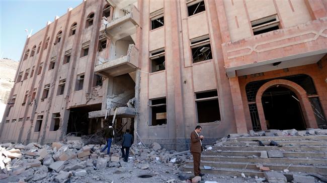 A picture taken on February 5, 2018, shows people gathering around the Yemeni criminal investigations unit in the capital Sana’a, a day after it was hit in a Saudi air raid. (Photo by AFP)
