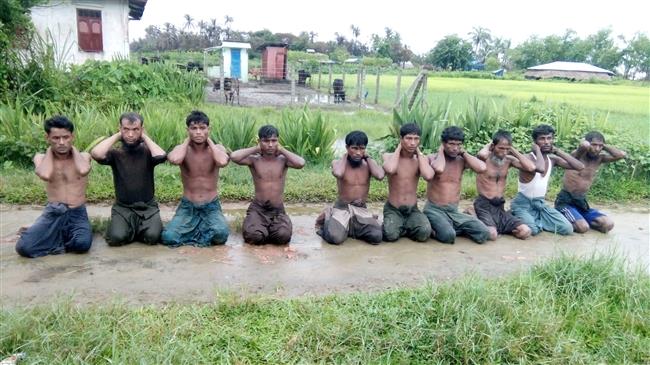 Ten Rohingya Muslim men with their hands bound kneel in Inn Din Village before they were summarily executed by Myanmarese soldiers and Buddhist mobs, on September 1, 2017. (Photo by Reuters)
