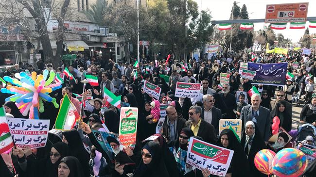 People in Shiraz carry placards during demonstrations to mark the anniversary of the Islamic Revolution on Feb. 11, 2018. (Photo by Mehr)
