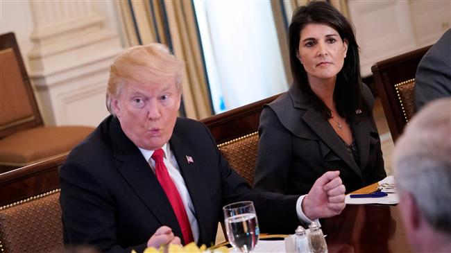 US President Donald Trump (L) speaks, watched by US Ambassador to the UN Nikki Haley, during lunch with members of the United Nations Security Council in the White House, January 29, 2018 in Washington, DC. (Photo by AFP)
