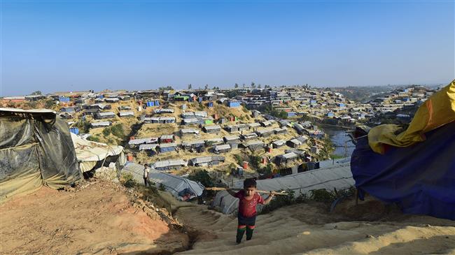 A Rohingya refugee child climbs stairs at Hakimpara refugee camp in Bangladesh