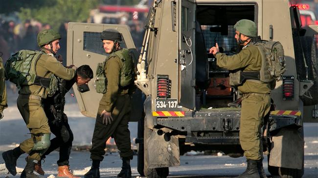 Israeli forces arrest a Palestinian protester near the Huwara checkpoint, south of Nablus, in the Israeli-occupied West Bank, on December 13, 2017, as protests continue in the region amid anger over US President Donald Trump