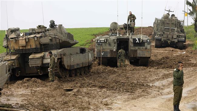 Israeli soldiers and their tanks are seen monitoring the area of the southern Gaza, on February 18, 2018. (Photo by AFP)