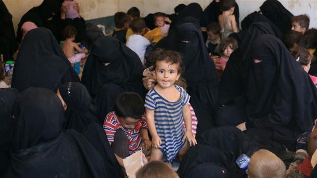 Families and relatives of Daesh Takfiri militants are seen after surrendering themselves to the Kurdish Peshmerga forces in al-Ayadiya, northwest of Tal Afar, Iraq, on August 30, 2017. (Photo by Reuters)
