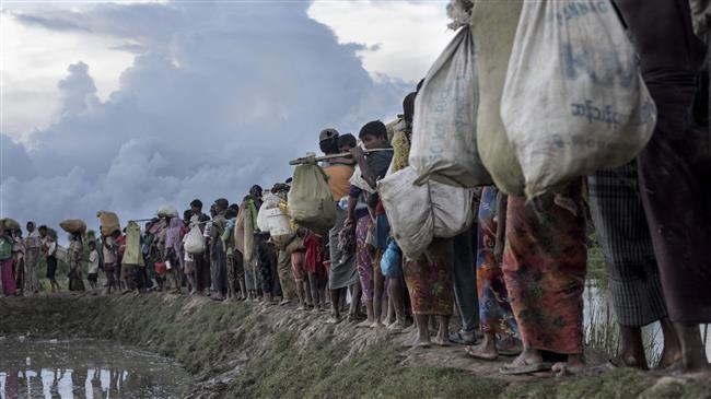 This file photo shows Rohingya refugees after crossing the Naf River from Myanmar into Bangladesh in Whaikhyang. (By AFP)
