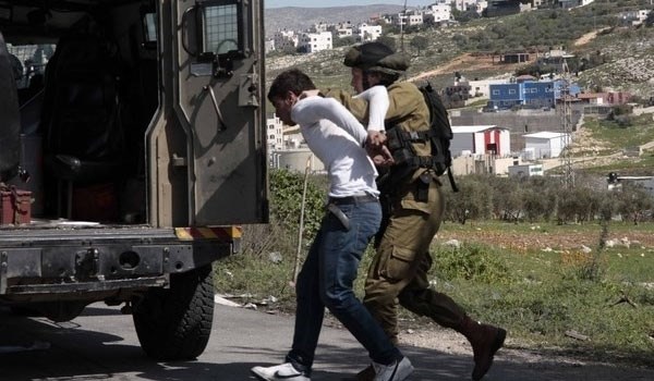 Israeli soldier arresting a Palestinian youth