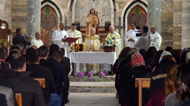 Louis Raphael Sako (C), the Patriarch of the Chaldean Church in Iraq, leads a mass at the Sacred Heart Chaldean church on January 20, 2018, in the city Tal Kaif, north of Mosul. (Photo by AFP)
