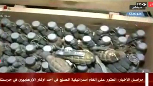 This picture shows a cache of Israeli-made weapons found inside a secret underground in the Syrian town of Harasta, Eastern Ghouta region, on March 28, 2018. (Photo by Syria’s state-run television network)
