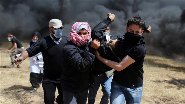 Palestinians carry a wounded demonstrator during clashes with Israeli forces following a protest east of the Jabalia refugee camp in the northern Gaza Strip on April 6, 2018. (Photo by AFP)
