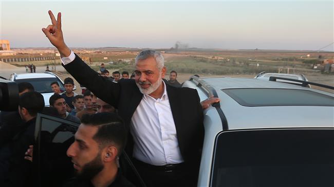 Hamas leader Ismail Haniyeh flashes the "V" for victory sign as he makes a stop on April 9, 2018 at the site of protests on the Israel-Gaza border east of Gazy City.
