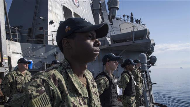 This US Navy photo obtained on April 11, 2018 shows sailors as they man the rails aboard the Arleigh Burke-class guided-missile destroyer USS Donald Cook (DDG 75) as the ship departs Larnaca, Cyprus, on April 9, 2018. (Photo by AFP)