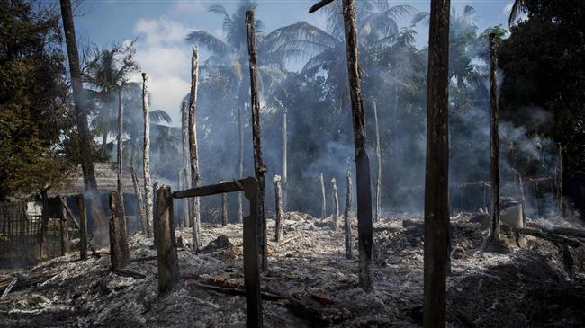 The photo, taken on October 14, 2016, shows smouldering debris of burned houses in an abandoned Muslim village in Warpait, Myanmar
