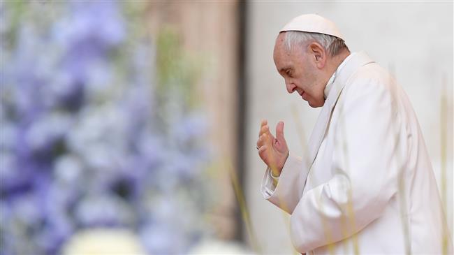 Pope Francis prays during a weekly general audience at St Peter