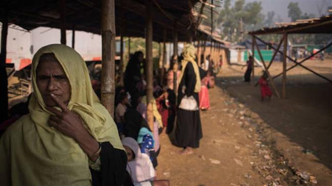 A Rohingya woman queues at a relief center at the Jamtoli refugee camp in Cox