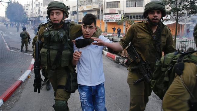 Israeli soldiers detain a Palestinian boy during clashes at a protest rally in the West Bank city of al-Khalil (Hebron), December 15, 2017. (Photo by AP)
