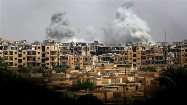 This picture taken on September 5, 2017, shows smoke billowing out following a US-led coalition airstrike in the western al-Daraiya neighborhood of the embattled northern Syrian city of Raqqah. (Photo by AFP)