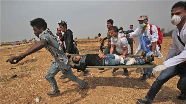 A wounded Palestinian protestor is evacuated near the border fence with occupied lands, in Rafah in southern Gaza Strip on April 20, 2018. (Photo by AFP)
