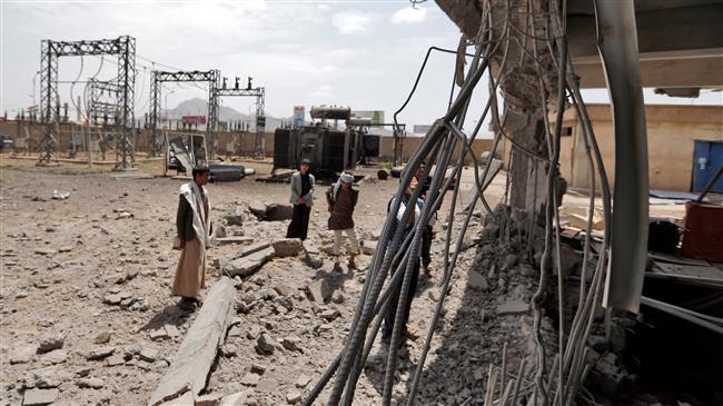 Yemenis check the damage in a power station in the aftermath of an air strike by the Saudi-led coalition in the Yemeni capital Sana