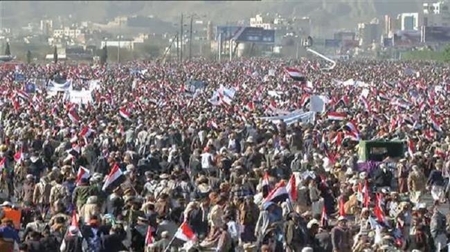 The image grab from al-Masirah television network shows people attending a massive rally to mark three years of Saudi aggression against Yemen, in Sana