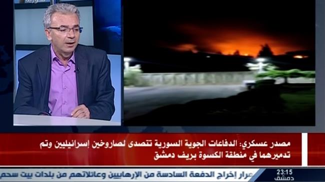 A TV grab from a broadcast by the official Syrian Arab News Agency (SANA) on May 8, 2018 shows a Syrian presenter speaking with images on the right showing the aftermath of two intercepted Israeli missiles. (Photo by AFP)
